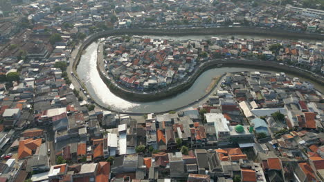Dirty Canal Winds Through Tebet Neighborhood Jakarta Indonesia Drone Track Back 4K 60FPS