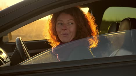 woman enjoying a drive at sunset