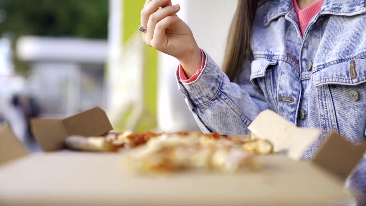 Woman Eating Pizza Outdoors