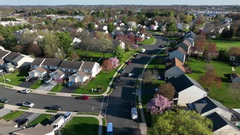 high aerial orbit shot of neighborhood in america during spring