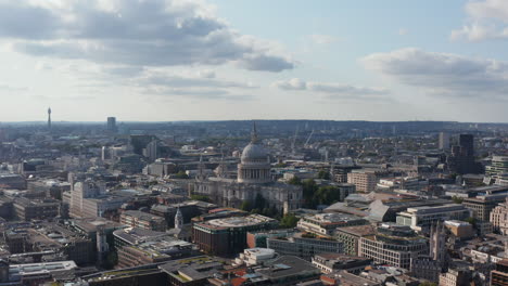 Forwards-fly-above-urban-district.-Heading-towards-historic-Saint-Pauls-Cathedral-with-large-dome.-London,-UK