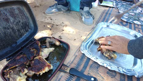 grilled lamb chops barbecued over embers in the middle of the desert in bivouac