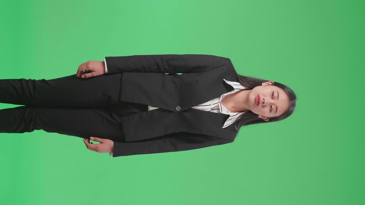 Jealous Asian Business Woman Looking In The Green Screen Studio