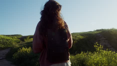 woman hiking on a sunny path