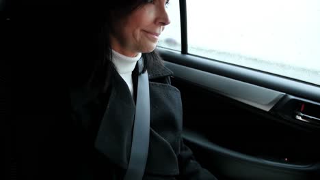 woman sitting in car and writing on diary