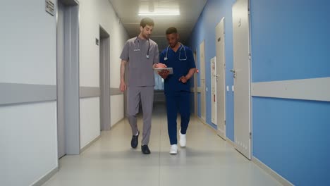 doctors discussing in hospital corridor