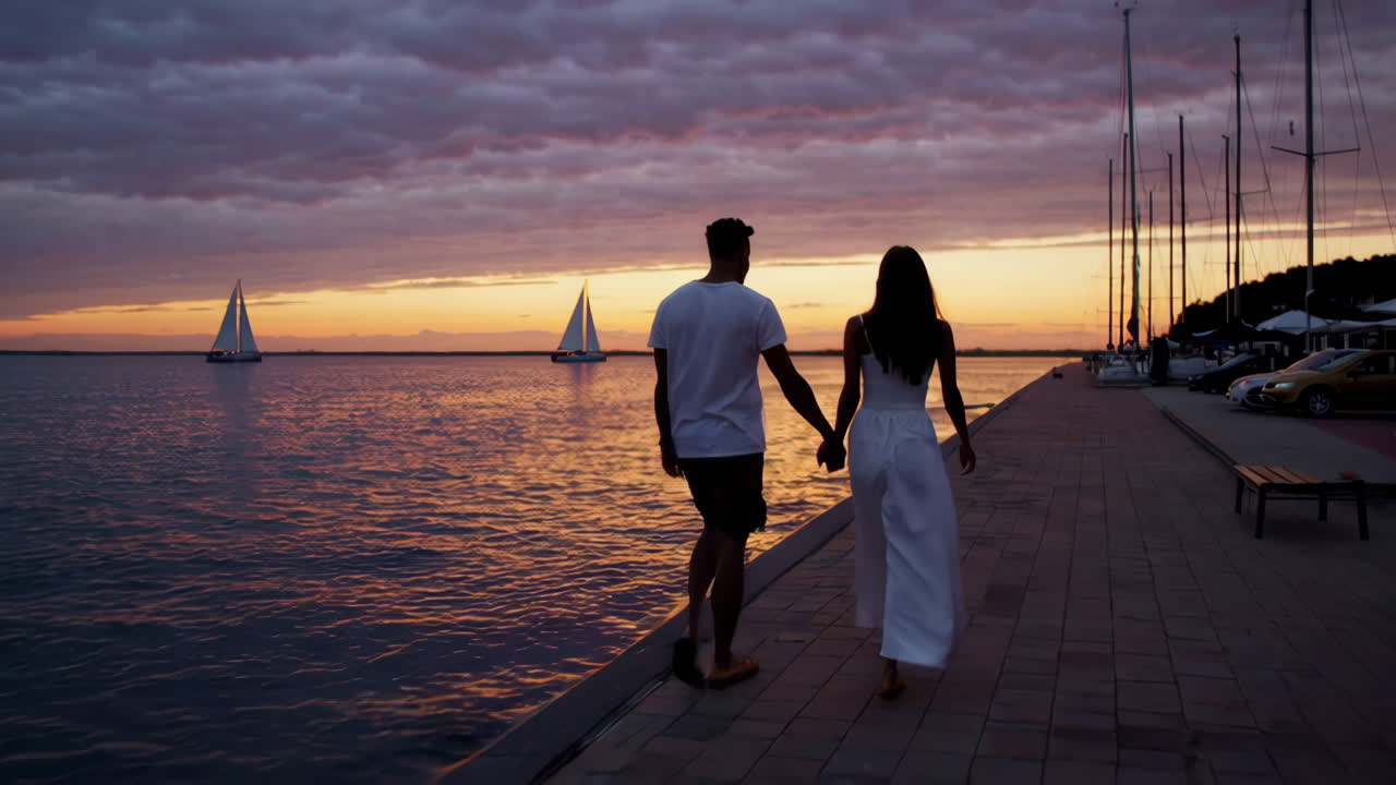 Couple Walking on Pier at Sunset