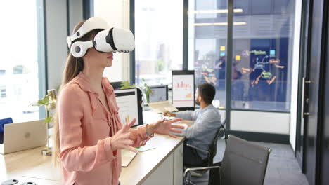 using vr headset, woman interacting with virtual environment in modern office