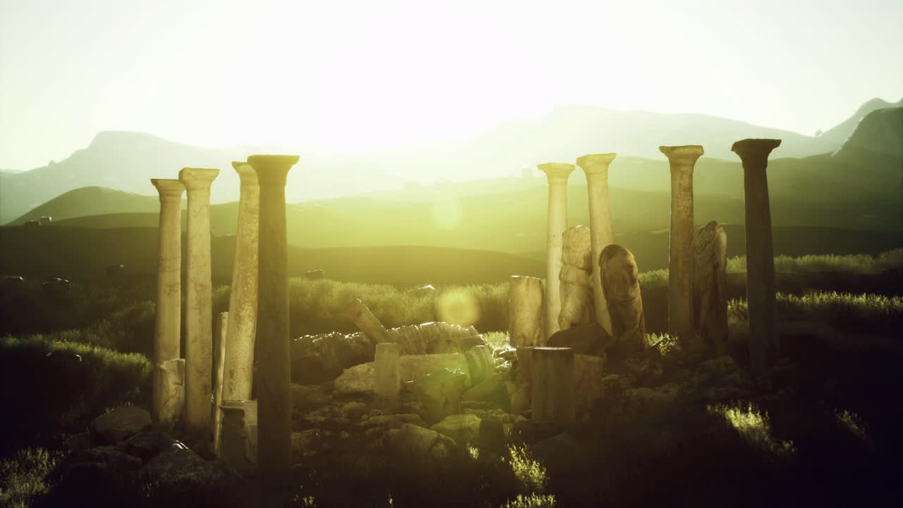 Ancient columns illuminated by sunset in a serene landscape
