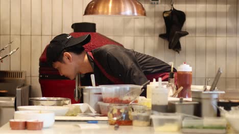 chef focused on cooking amidst a bustling kitchen