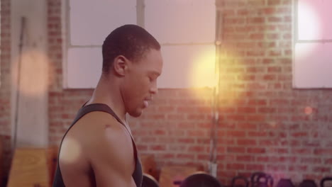 man exercising in gym with bokeh light animation over brick wall background