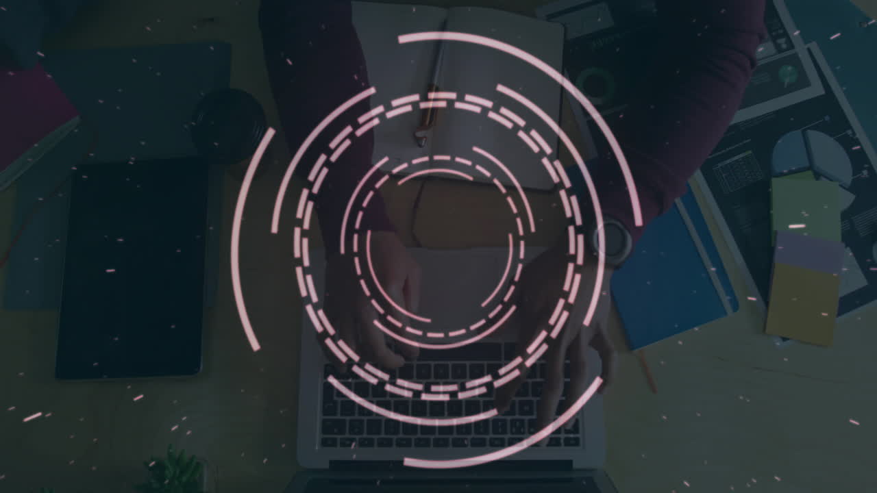 Circular digital interface animation over person typing on laptop at desk