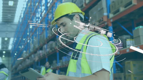 animation of scope scanning and globe over man using tablet in warehouse