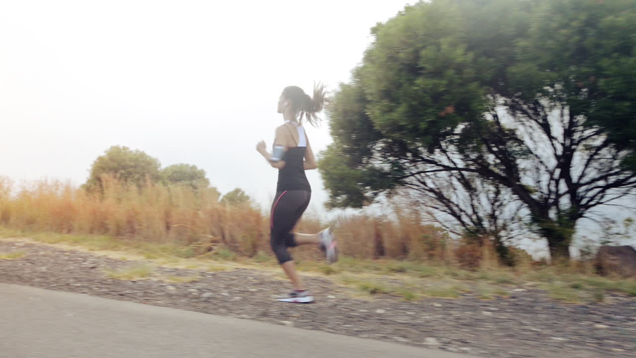 woman running on road close up shoes steadicam shot