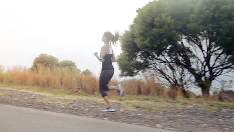 mujer corriendo en la carretera de cerca zapatos steadicam tiro