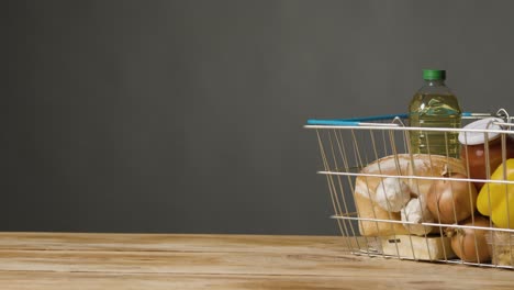 Studio-Shot-Of-Basic-Food-Items-In-Supermarket-Wire-Shopping-Basket-10