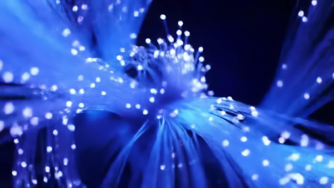Experience the mesmerizing display of blue fiber optic lights radiating in a dark setting, creating a tranquil and enchanting atmosphere perfect for relaxation or inspiration.