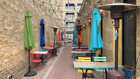 Colorful-dining-area-between-buildings-during-a-day-outside