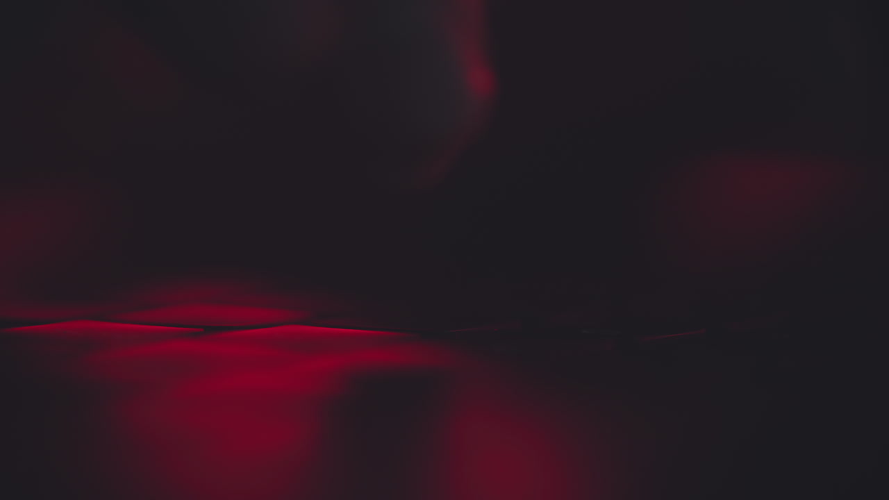 Close-up of fingers on a dark keyboard