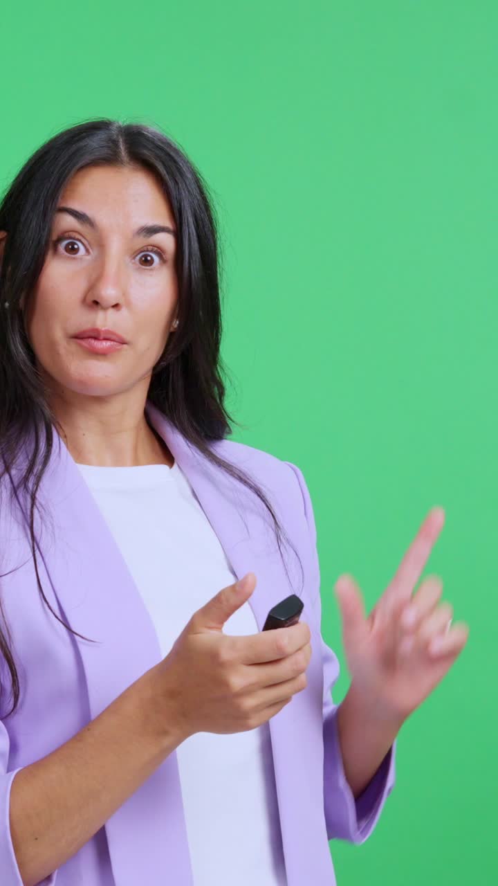 Confident female speaker giving a presentation on a green screen