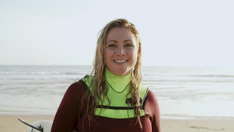 happy female surfer smiling at camera