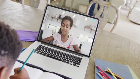 Composition-of-african-american-boy-on-laptop-online-learning-with-biracial-schoolgirl