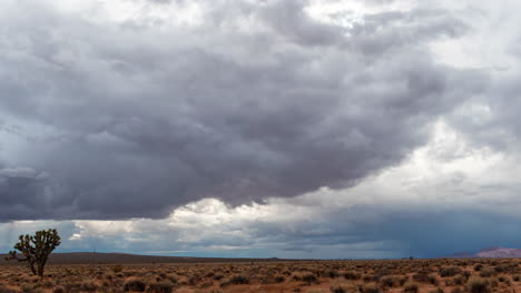 rain clouds forming abstract shapes over the arid and thirsty mojave desert landscape - fast developing time lapse