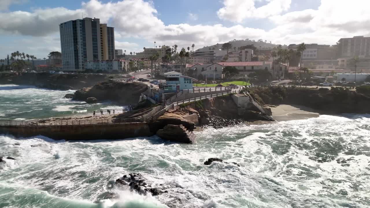 Gentle swells push toward La Jolla beach with clear midday lighting near San Diego California