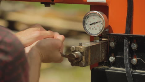 construction worker operating a large machine in a lumber yard