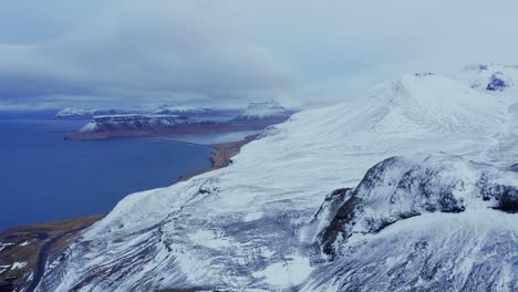 snowy peninsula of snaefellsnes at winter overlooking fjord in iceland with kirkjufell mountain