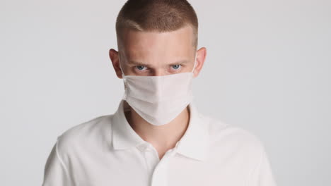 angry man wearing white face mask