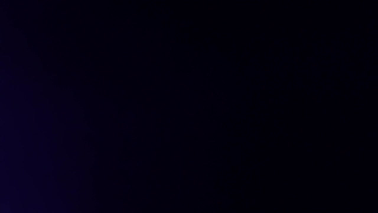 Rays of colorful light in a dark room from lanterns