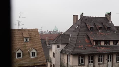 gazing upon the rooftops of strasbourg on a misty and atmospheric day, the captivating panorama unfolds with a harmonious fusion of both german and french architectural styles