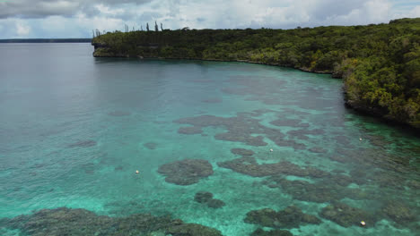 low aerial flyover of natural marine reserve jinek's bay, lifou, new caledonia