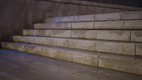 close-up view of a wet stone staircase at night, details of the steps under soft lighting