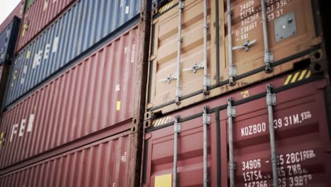 colorful shipping containers are stacked neatly at a bustling port, highlighting the efficiency of global trade and logistics operations during daylight hours.