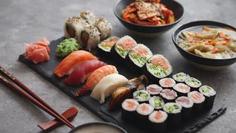 Various-kinds-of-sushi-placed-on-black-stone-board