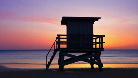 lifeguard tower silhouette at sunset over the ocean