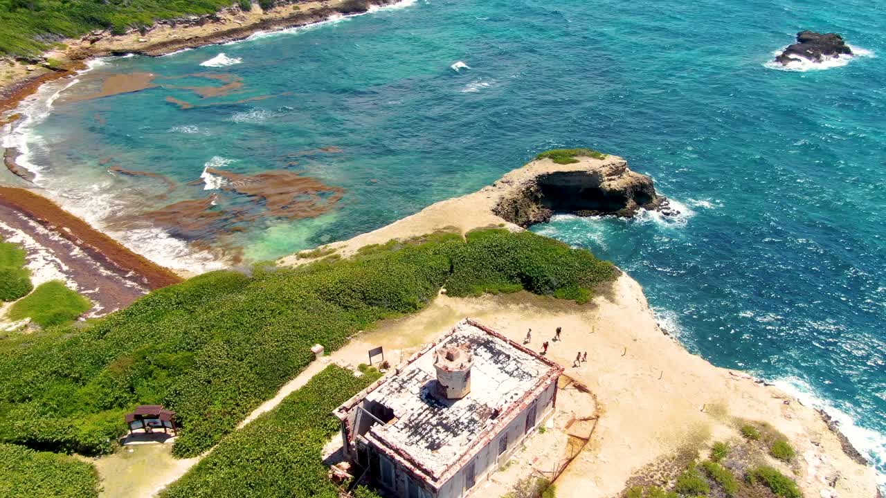 Tourists Strolling by Puerto Ferro Lighthouse in Vieques, Puerto Rico - Orbit Drone Shot