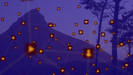 Animation-of-network-of-digital-icons-against-landscape-with-mountains-and-trees