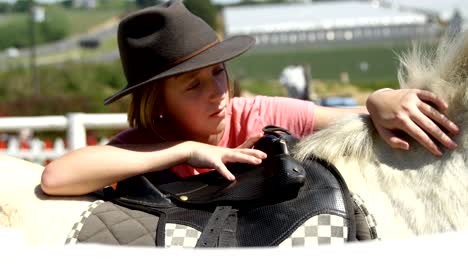 girl petting a horse in the ranch 4k