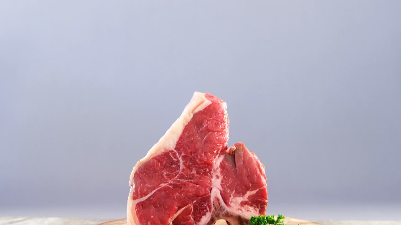 Raw meat and parsley on wooden table
