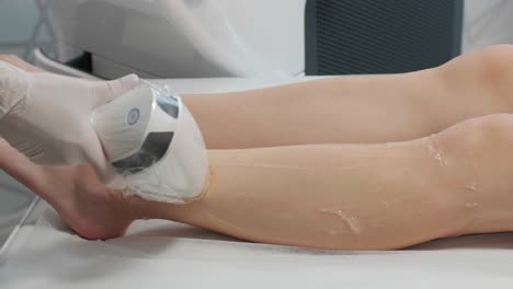 laser epilation - hair removal procedure. flash of diode laser hair removal, beautician removes hair on beautiful female legs, hair removal for smooth skin, laser procedure at beauty studio or clinic, body care epilation treatment.