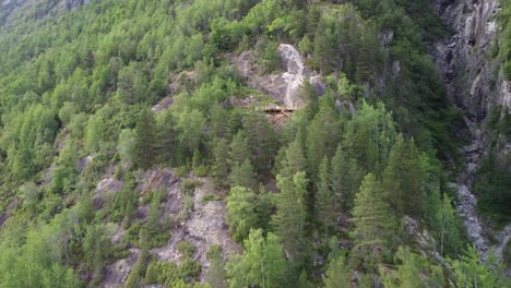 upward moving aerial along via ferrata loen mountain climbing trail - risky path close to cliff at steep mountain - norway