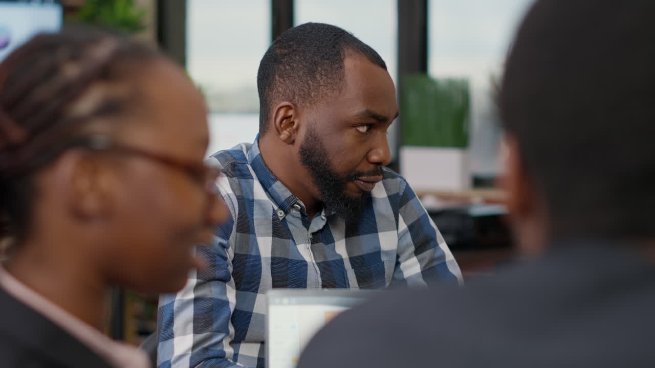 Business man talking to colleagues at boardroom meeting