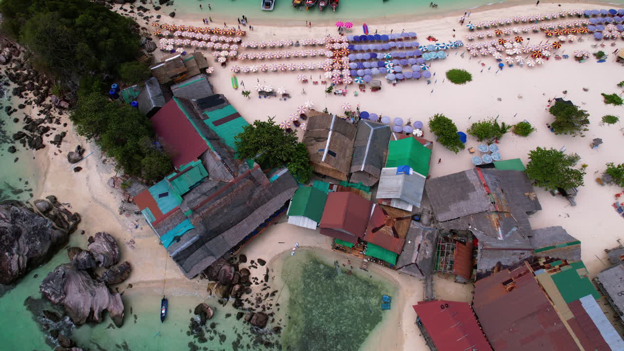 Aerial tilt shot descending in front of the town on Ko Khai Nok island, Thailand