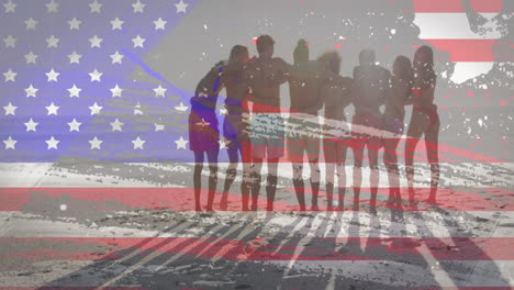 bandera estadounidense con efecto de falla contra un grupo de amigos de pie juntos en la playa