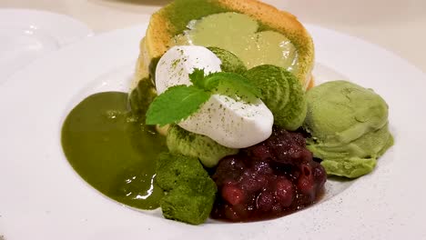 souffle pancake, matcha flavor with red bean mashed and green tea ice-cream, topping melting and falling down