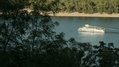 Speedboat-passes-river-cruise-on-the-Dnieper-River-Kiev-on-a-warm-autumn-evening