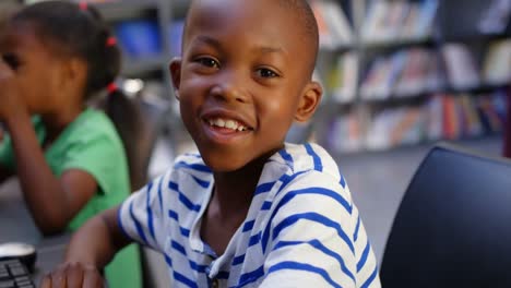 front view of african american schoolboy studying on computer in the classroom 4k